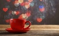 Red cup of tea in heart bokeh background
